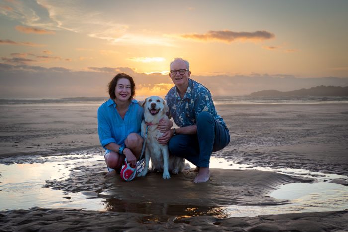 Family with pet at beach