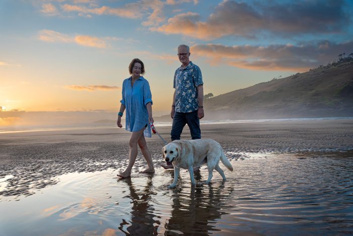 Family with pet at beach