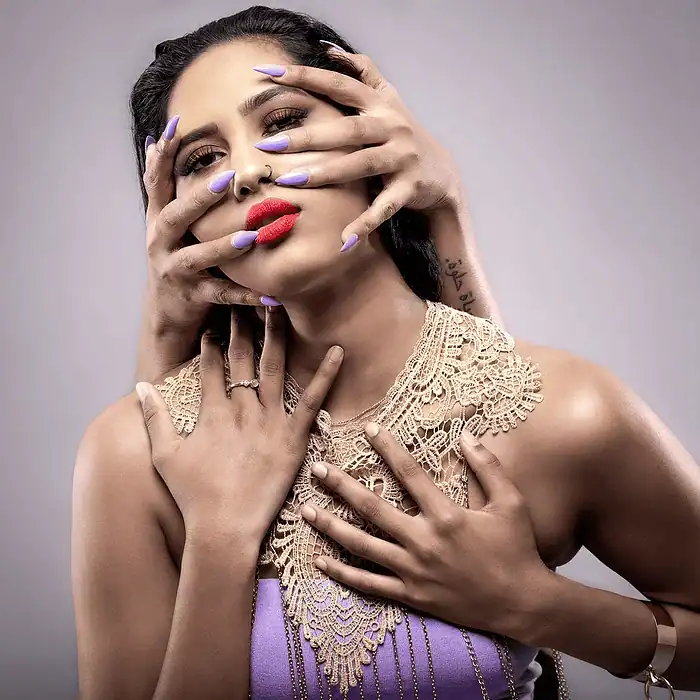 Elegant close portrait of a woman with graceful hands partially covering her face