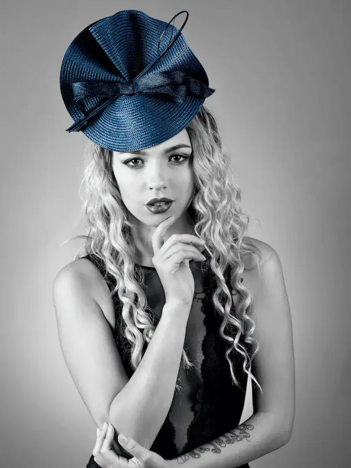 Black and white portrait of a woman wearing a fancy hat