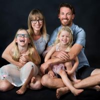 Happy family posing together in a studio