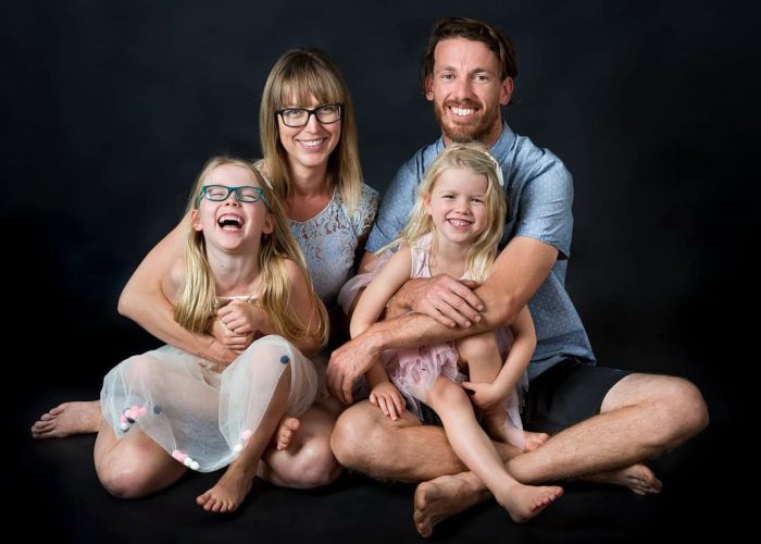 Happy family posing together in a studio