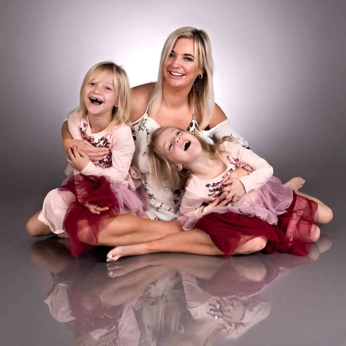 Studio portrait of a mother and her daughters sharing a moment