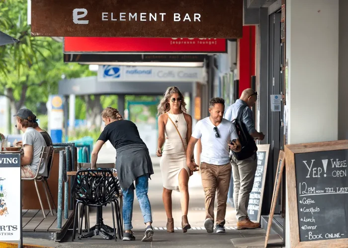 Business professionals walking and talking along a street of shops during a photoshoot