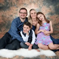 Happy family posing together in a studio