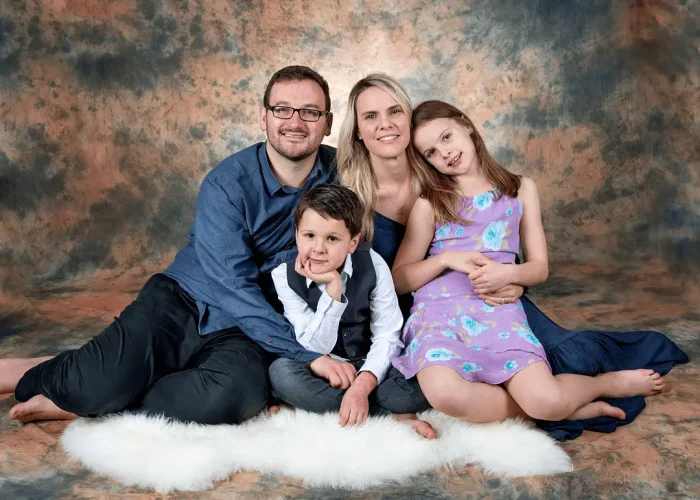 Happy family posing together in a studio