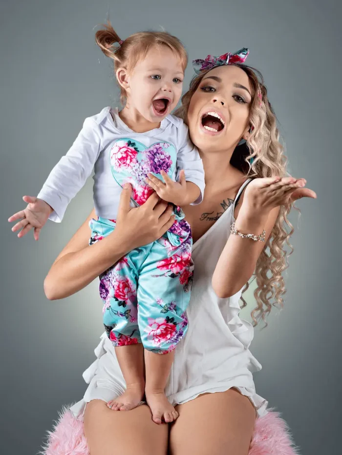 Mother and child happily posing in a studio