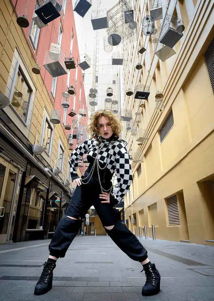 Fashion portrait of a woman in a cool outfit on Angel Place in Sydney with hanging bird cages above