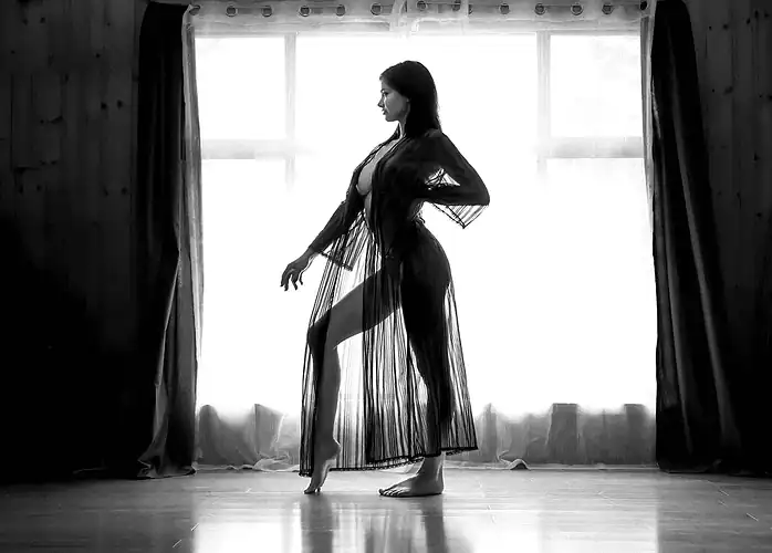 Fashion portrait of a woman posing by a window
