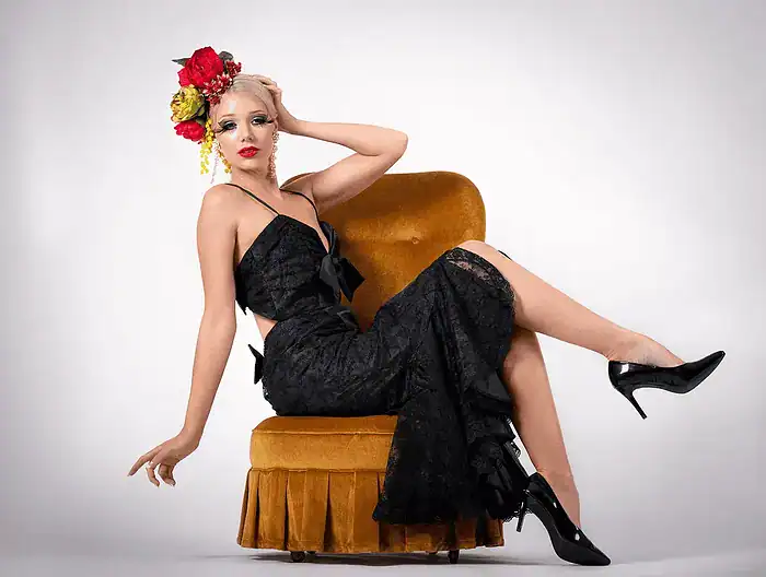 Glamour portrait of a woman sitting elegantly on a chair
