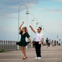 Couple walking and having fun along Coffs Jetty