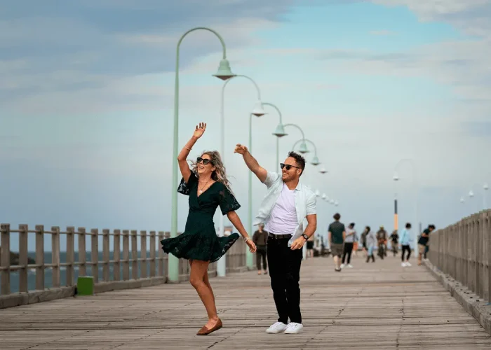 Couple walking and having fun along Coffs Jetty