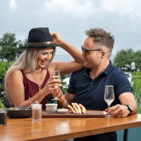 Couple sitting outdoors enjoying a drink together