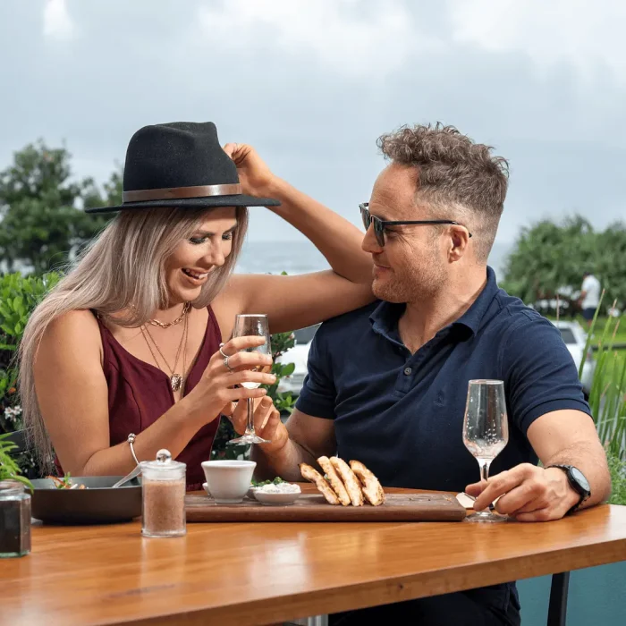 Couple sitting outdoors enjoying a drink together