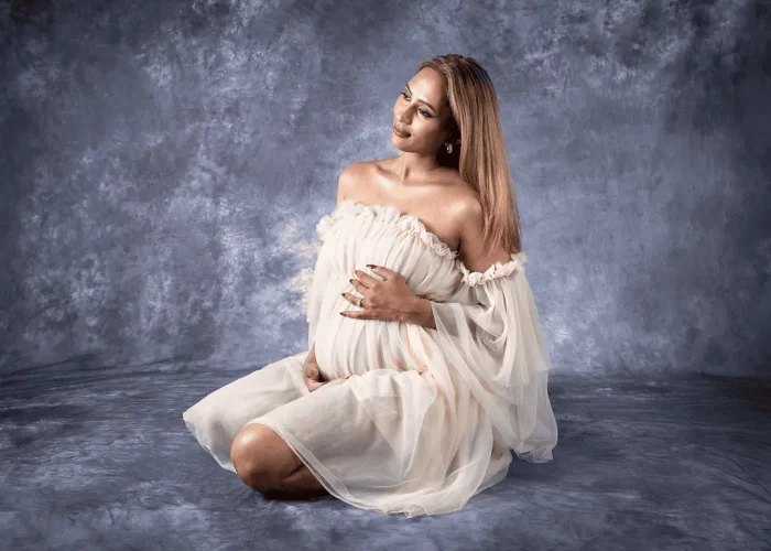 Pregnant woman posing in a studio for maternity portrait