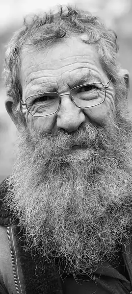 Black and white portrait of an elderly man with a beard