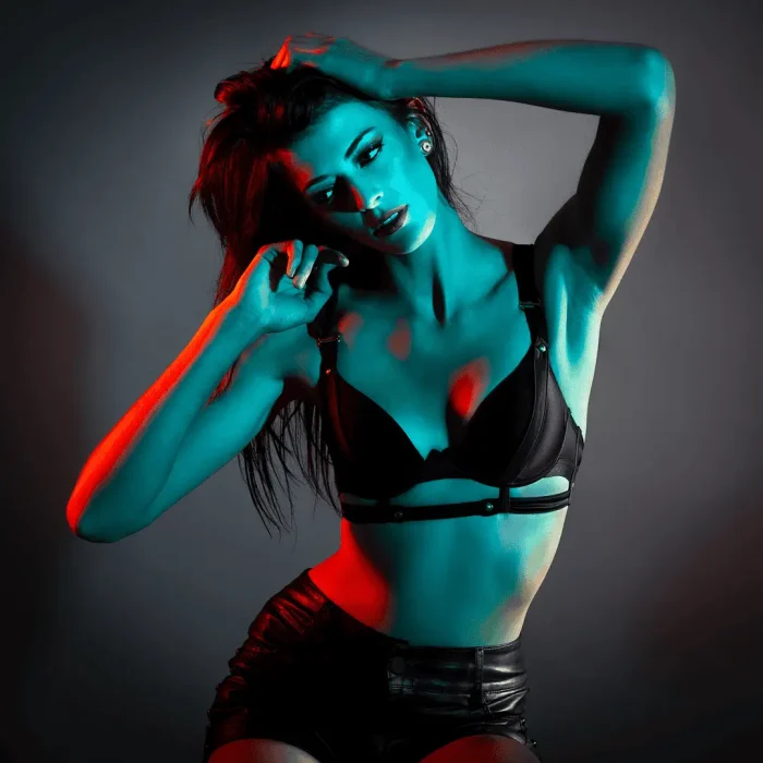 Black-and-white studio portrait of a lady with backlit red lighting