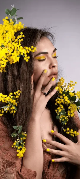 Portrait of a First Nations lady surrounded by yellow blossoms