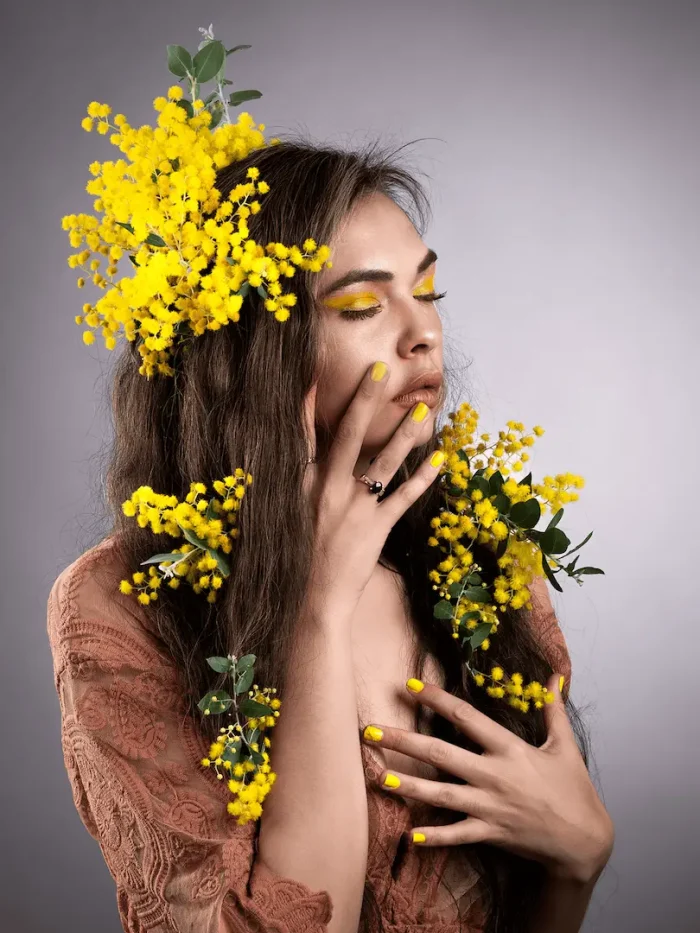 Portrait of a First Nations lady surrounded by yellow blossoms