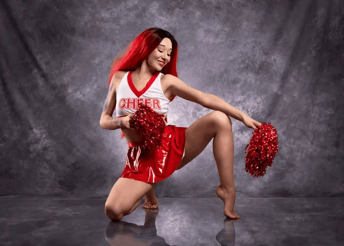 Studio cosplay portrait of a lady dressed as a cheerleader
