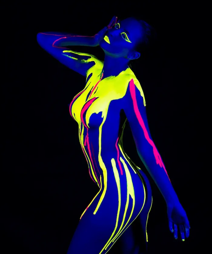 Studio portrait of a girl in coloured body paint with creative lighting effects