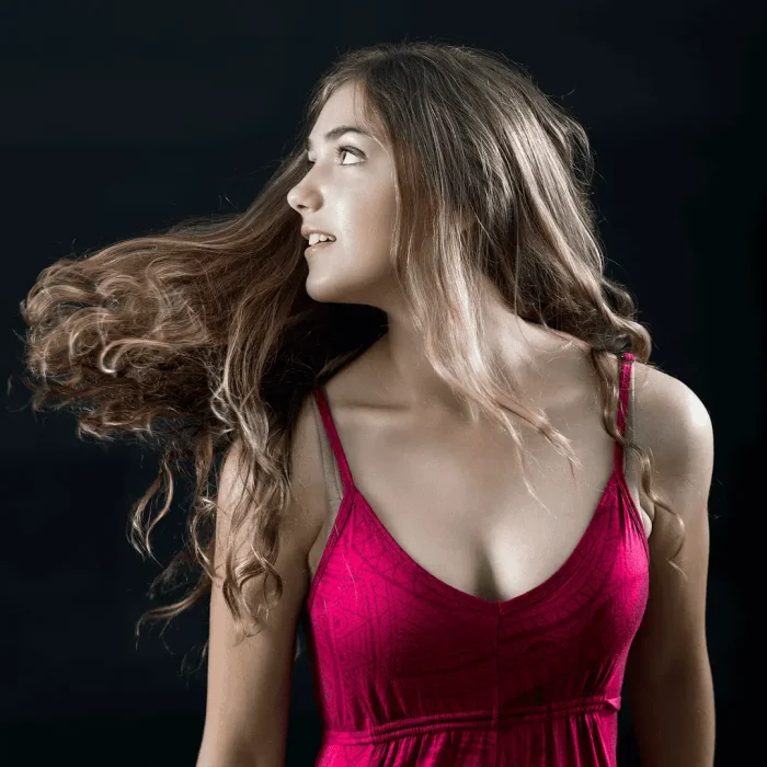 Portrait of a girl flicking her hair in a studio